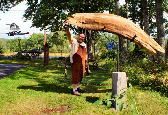 Andy standing with his whale sculpture.