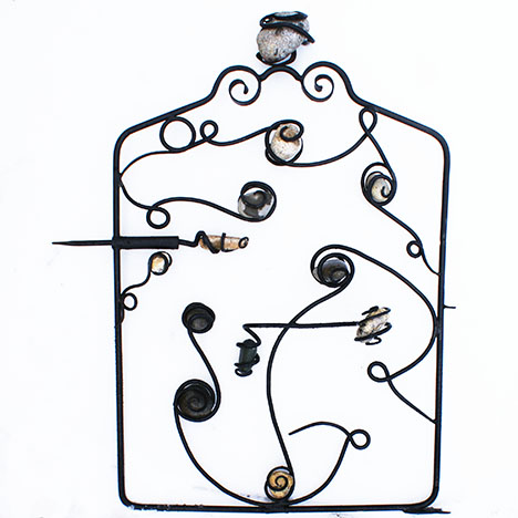 Gate with rocks wrapped in iron.