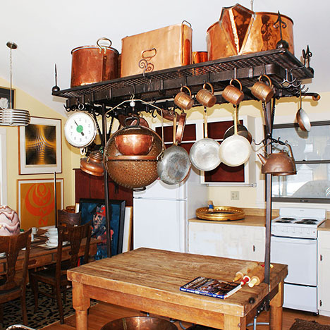 3 wrought iron catails and a bowl set in a bowl holder.