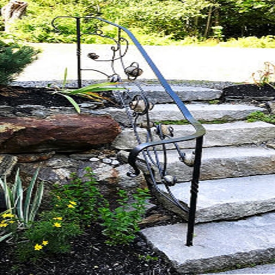 Railing with stones encased in wrought iron on six steps of granite.